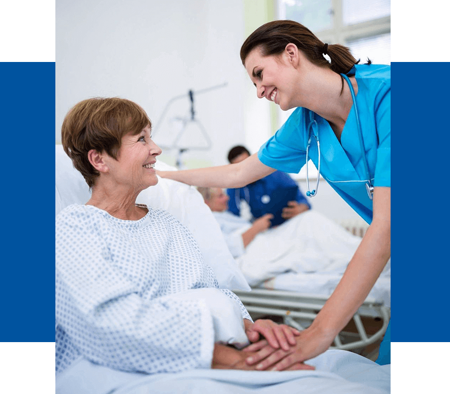Nurse comforting a patient in a hospital room.